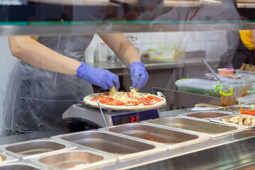 Process of making pizza in the bakery