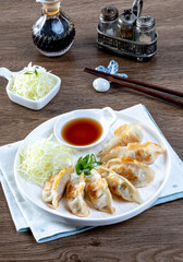 Fried dumplings gyoza with soy sauce. Gyoza or dumplings snack. Japanese dumplings Gyoza with chicken and vegetables.