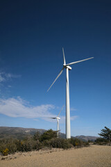 Wind turbine with blue sky at background