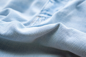 Old denim blue jeans fabric texture background close up