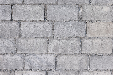 Concrete block wall background consist of rough surface of texture cement and gravel. Pattern of rectangle shape masonry in stacked row horizontal in construction building work. Suit for background.