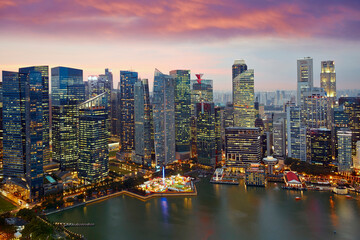 The urban skyline of Singapore's Marina Bay CBD under the evening glow.