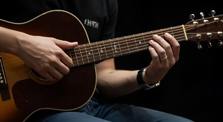 Person playing acoustic guitar strumming strings on fretboard close up detail shot