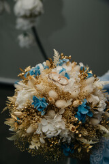 a bouquet of wildflowers and decorative flowers tied together and with gold decorative inserts between them lies on an isolated background for a wedding or birthday or anniversary celebration