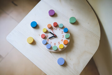 Learning Clock Toy with Shapes on Wooden Surface