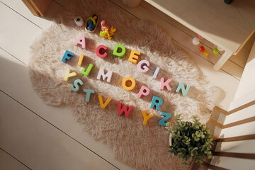 Wooden Alphabet Letters on Beige Rug