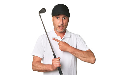 Middle aged golfer man pointing to the side
