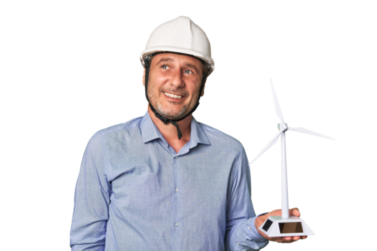 A middle-aged architect man holding a windmill model dreaming of achieving goals and purposes