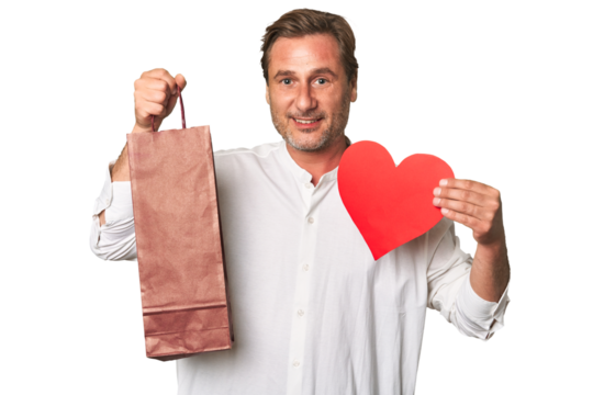 Mature gentleman exudes refined charm, holding a heart and wineglass in this classic studio portrait.