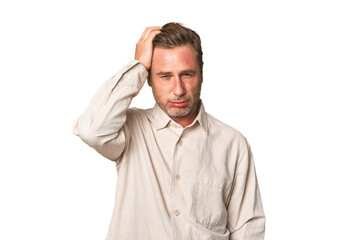 A middle-aged man isolated tired and very sleepy keeping hand on head.