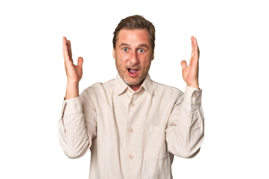 A middle-aged man isolated celebrating a victory or success, he is surprised and shocked. - Powered by Adobe