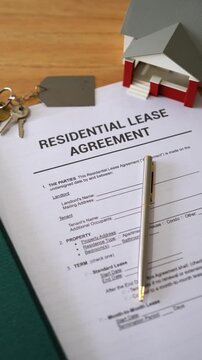 Vertical shot of residential lease agreement documents. Concept of renting a home.