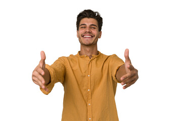 Young handsome caucasian man isolated on white background showing a welcome expression.