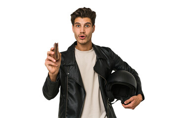 Fototapeta premium Young caucasian man holding a helmet isolated