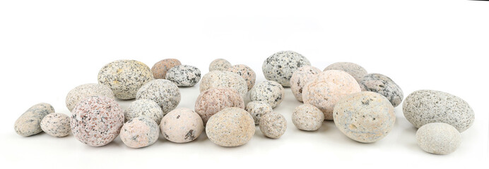 Sea washed oval pebbles isolated on white background. Arrangement of smooth round stones.