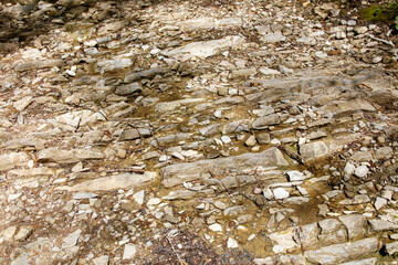 A rocky, barren landscape with a few small rocks scattered around