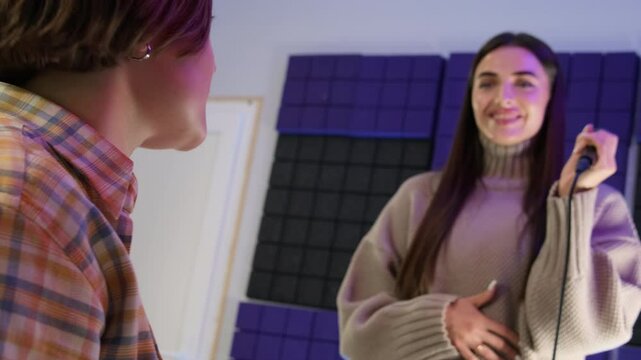 Teacher encourages student to embrace vocal challenges. Lady and instructor collaborate on vocal performance objectives during lesson slow motion