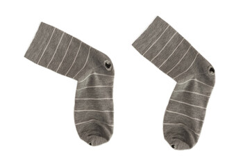 A pair of gray striped socks with holes. White background, isolated.