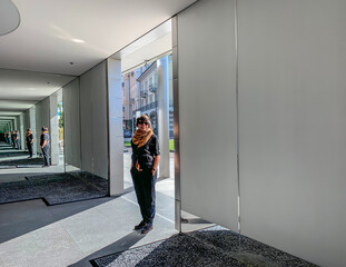 Woman Standing on a Street with Mirror in a Sunny Day in switzerland.