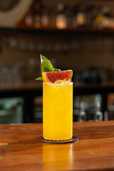 Orange Fruit Based Cocktail on a Wooden Bar Counter