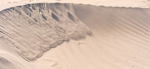 After the storm, sand dunes. A beautiful natural phenomenon. Dune landscape. Sandy shore. Sunny day.