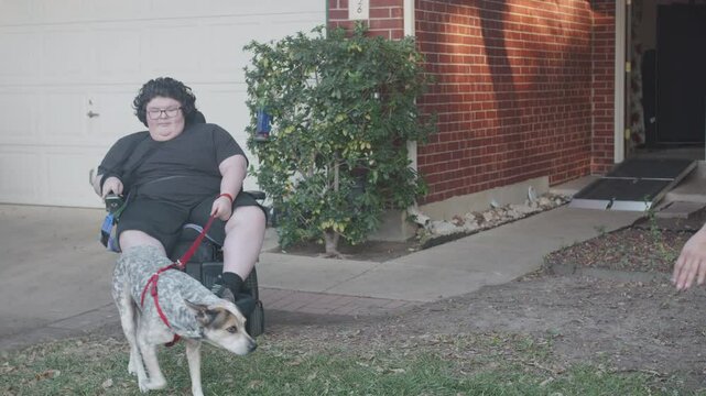 Muscular Dystrophy adolecsent in wheelchair with dog and mom leaving home