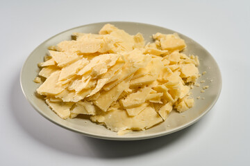 Aged cheese flakes on plate