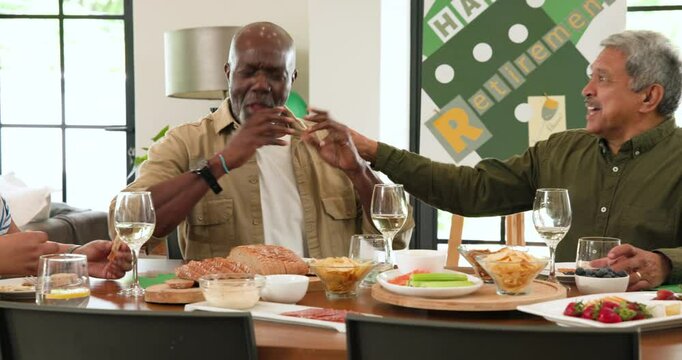 Group of happy senior multiracial, white and black male and female friends talking at retirement par