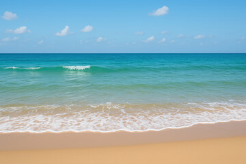 Obraz premium Calm ocean waves gently wash onto sandy beach under clear blue sky with scattered clouds, creating peaceful and relaxing coastal scene