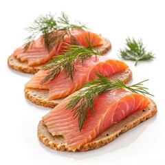 Appetizing smoked salmon canap�s garnished with fresh dill on a white background