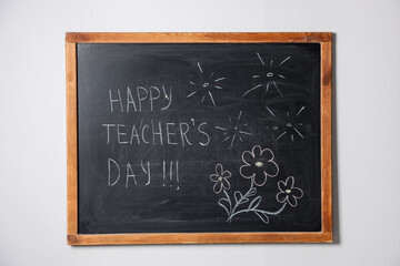 Phrase Happy Teacher&rsquo;s Day with exclamation marks and drawings on blackboard
