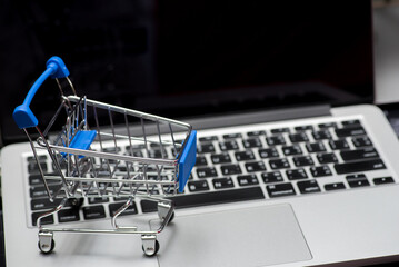 close up of Cart on keyboard computer with tablet background (Online shopping)
