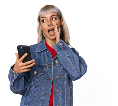 Caucasian young woman with a smartphone shouting and holding palm near opened mouth.