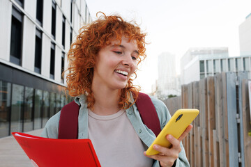 Young student engaging with smartphone outdoors