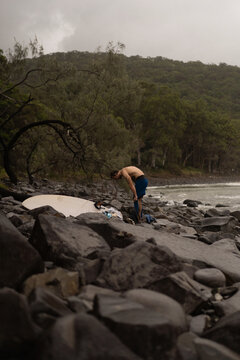 Man takes off wetsuit after surfing