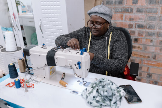 Black women sewing at a sewing machine
