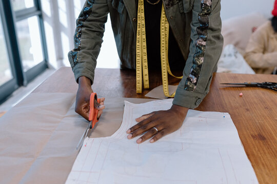 Dress maker cutting a pattern