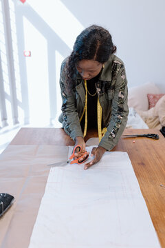 Women cutting a dress pattern