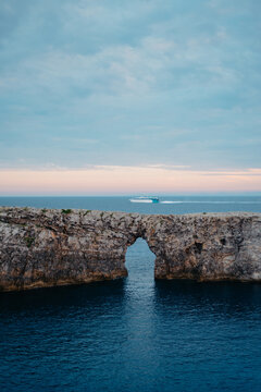 Speed Ferry Passing Pont d&rsquo;en Gil at Sunset, Menorca, Balearic Islands