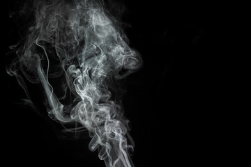 Elegant wisps of smoke rising against a dark background create a captivating visual effect and atmosphere, showcasing fluid movements and intricate patterns