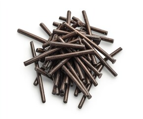 Dark brown metal rods piled high, various lengths and thicknesses, against white background.  They have a slightly rough texture