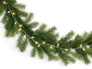 Seamless decorative christmas border with lights garland and coniferous branches isolated on white background