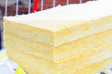 Close-up of the rockwool delivered on construction site for insulation of the walls of new built houses. Mineral wool for  house insulation to reduce energy bill