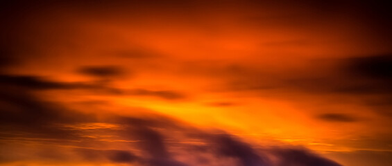 Obraz premium Orange coloured sunrise in clouds and sky