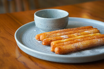 Churros with white chocolate, captured on May 13, 2025. Crispy golden churros paired with smooth, melted white chocolate for a sweet and indulgent treat