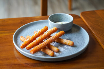 Churros with white chocolate, captured on May 13, 2025. Crispy golden churros paired with smooth, melted white chocolate for a sweet and indulgent treat