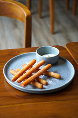 Churros with white chocolate, captured on May 13, 2025. Crispy golden churros paired with smooth, melted white chocolate for a sweet and indulgent treat