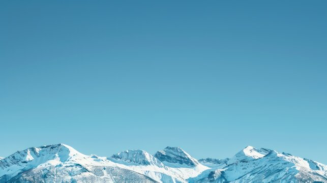 Snow-capped mountains against a clear blue sky as a retirement background.