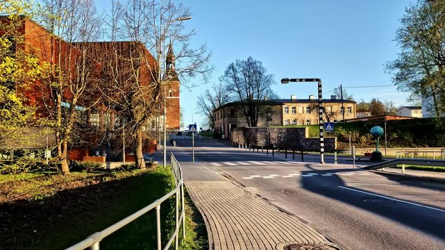 Empty street with view on St. Simon&rsquo;s Church and renovated theater in Valmiera, Latvia