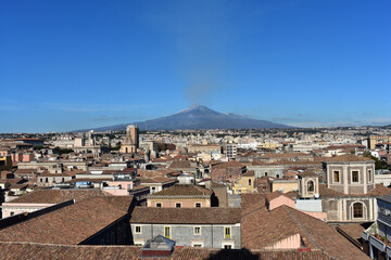Obraz premium Catania cityscape with the view of Etna volcano in Sicily, Italy. Catania downtown top view with Etna at background. 